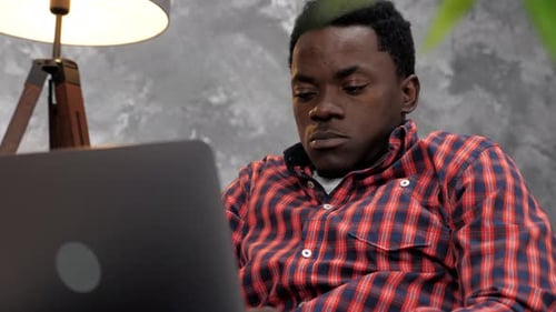 Adult African American Man Freelancer Works for Laptop Typing Text on Keyboard