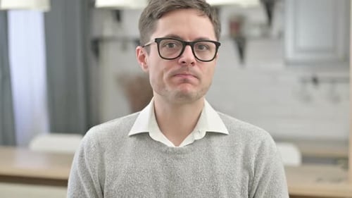 Portrait of a Man Wearing Glasses Indoors
