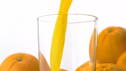 Fresh Orange Juice Pouring Into a Glass