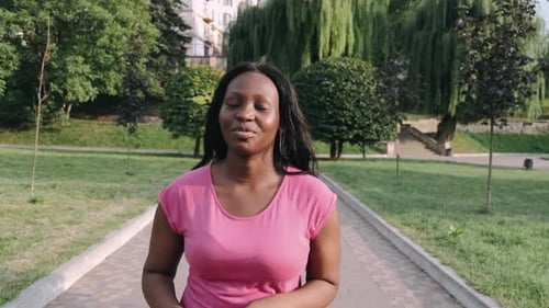 Young Active African American Woman Jogging in Park To Keep Healthy