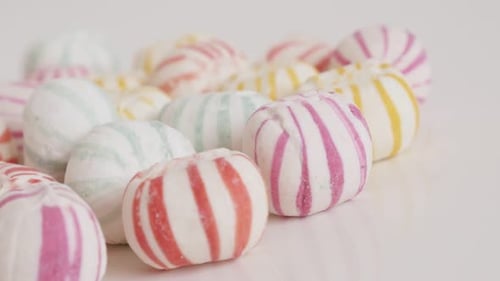 Slow panning on striped sugar bonbons close-up 4K footage