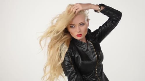 Fashionable Beautiful Blonde Woman Posing in Studio in Black Dress. Sexy Look. Slow Motion.