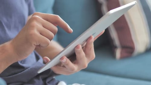 Close Up of Person Using Tablet Device Indoors