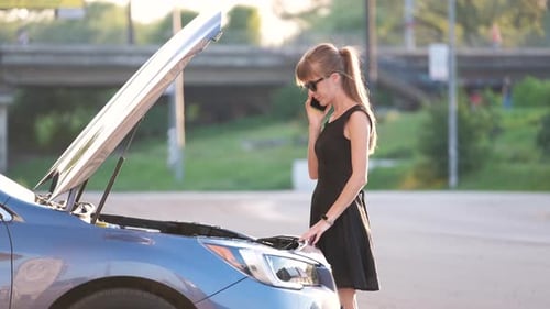 Helpless Woman Standing Near Her Car with Open Bonnet Calling Road Service for Help