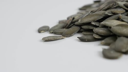 Pile of Green Pumpkin Seeds on White Surface