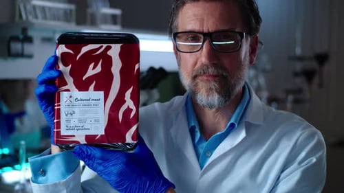 Scientist Holding Package of Cultured Meat in Lab
