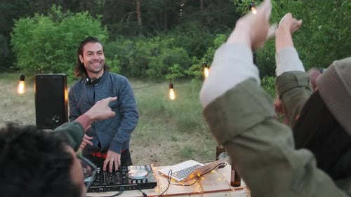 DJ Playing Music for Dancing Friends at Party