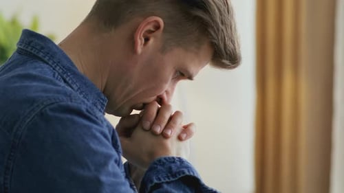 Man With Clasp Hands Looking Down