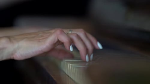 Close-up of a Woman's Hands with a White Manicure Playing the Piano Close-up.