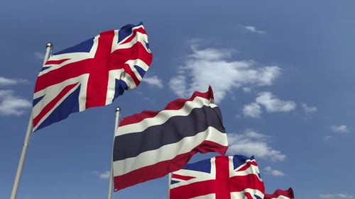 Thailand and UK Flags Waving Realistic Animation on Blue Sky