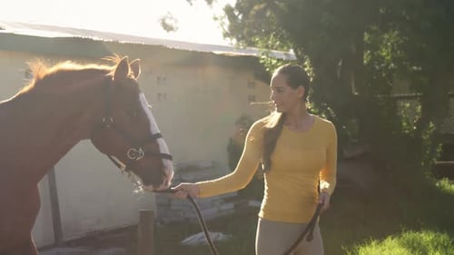 Woman walking with the horse in the ranch