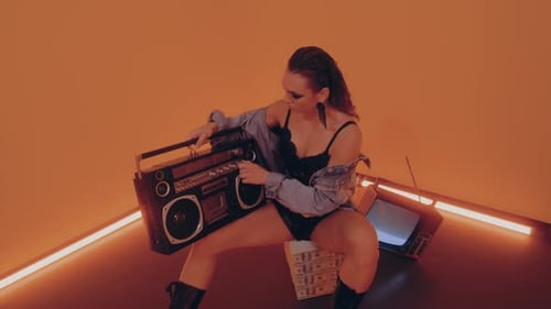 Woman Sits with Boombox and an Old TV