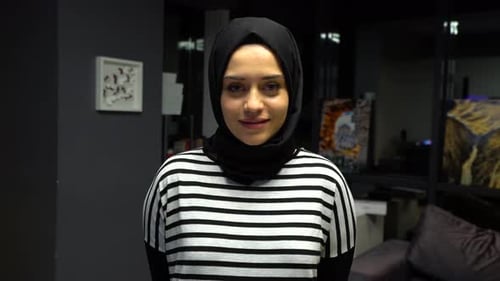 Woman with headscarf posing indoors