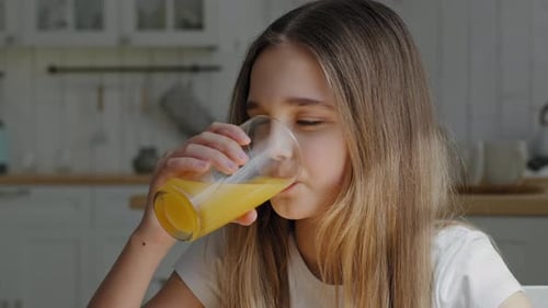 Portrait Caucasian Little School Girl Child Daughter Preteen Kid Feels Thirsty Drinks Orange Juice