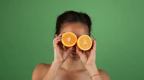 Gorgeous Happy Female Smiling Holding Oranges on Green Chromakey 1080p