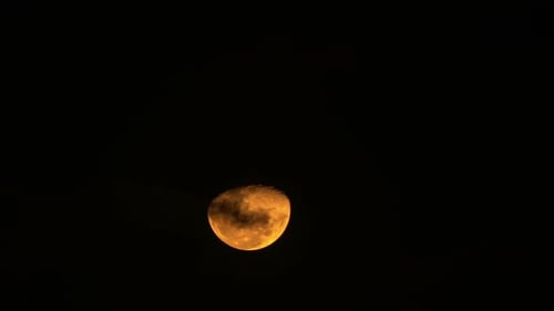 Glowing Moon in the Night Sky with Clouds