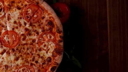 Delicious Pizza with Tomatoes and Cheese on Wood