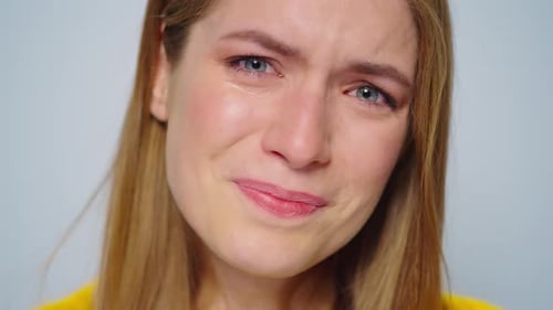 Closeup Crying Woman Posing with Sad Mood on Grey Background in Studio