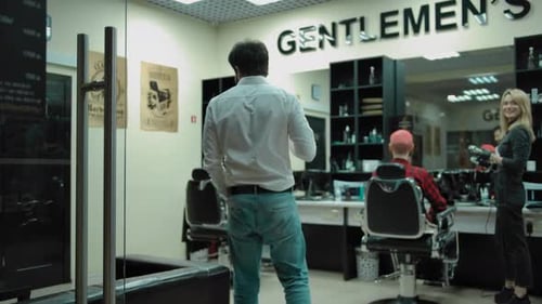 Bearded Customer Greeting Barbers in Salon