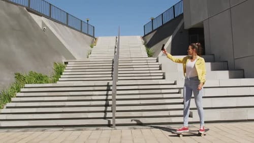 Woman on Skateboard Taking Selfie in City
