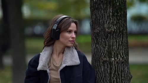 Woman Is Enjoying Nature and Communicating with It at Autumn Day in City Park, Listening To Melody