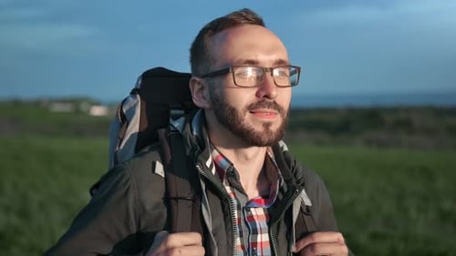 Man with Backpack Standing Outside