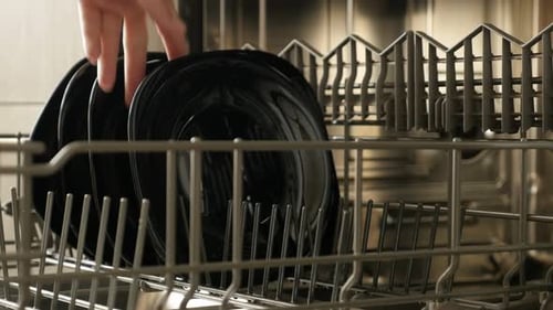 Black Dishes Being Unloaded From the Dishwasher