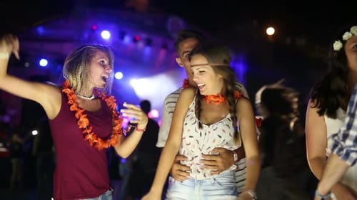 Young Adults Dancing at an Outdoor Concert