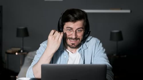 Close-up of a Young Man Talking Online Swearing, Angry Looking at the Computer, Using a Laptop