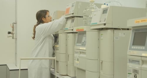 Scientist Adjusting Vial on Medical Testing Equipment