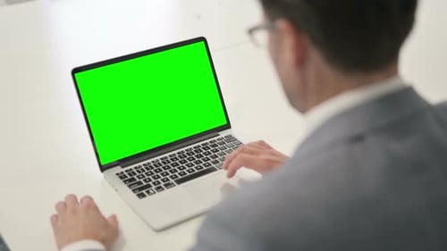 Man using Laptop with Green Chroma Screen