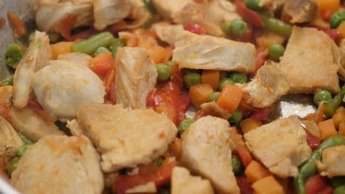 Tasty lunch preparing in frying pan close-up 4K 2160p 30fps UltraHD video - Colorful mix of frozen v