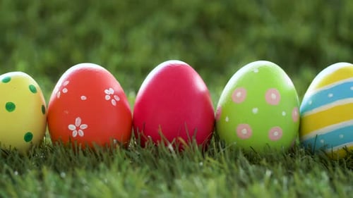Row of Colored Easter Eggs on Artificial Grass