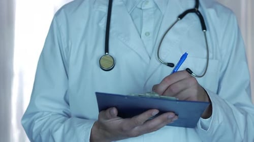 Doctor Writing Prescription In Hospital