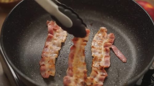 Crispy Bacon Sizzling in a Pan