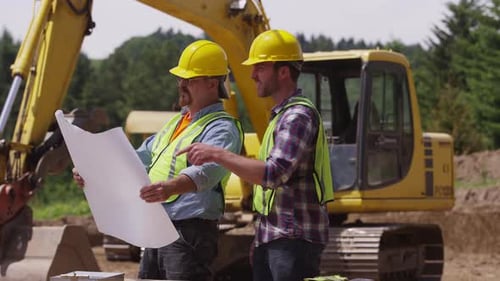 Construction workers looking at plans