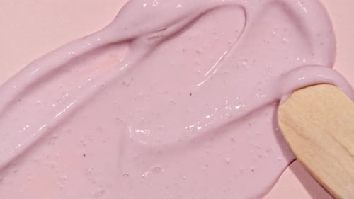 Pink Cream Spreading with Wooden Spatula Close Up