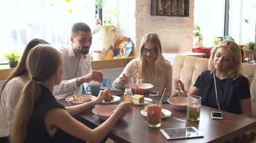 Colleagues Enjoying Casual Lunch Together Indoors