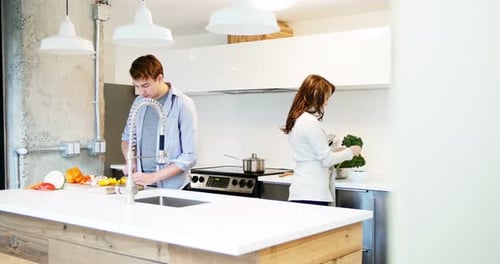 Young Couple Cooking Together in Modern Kitchen