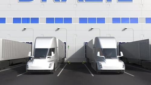 Trailer Trucks at Warehouse Dock with PRODUCT OF BRAZIL Text