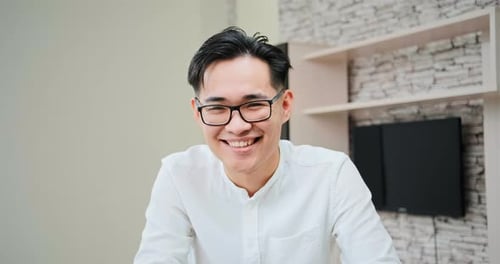 Smiling Young Adult Indoors Wearing Glasses