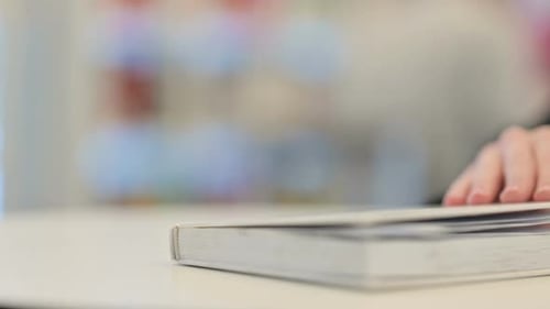 Female Hands Flipping Pages of Book Close Up