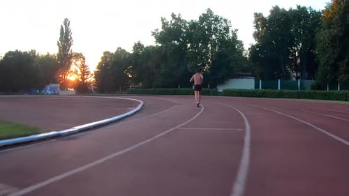 Man athlete jogging, training of stadium