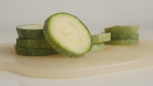 Healthy zucchini on pile close-up 4K 2160p 30fps UltraHD tilting footage - Slices of Pepo cylindric