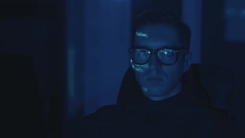 Man Wearing Glasses Looking at Code on Screen