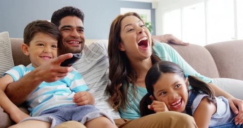 Happy Family Laughing Together on Couch