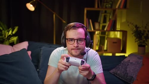 Excited Man Playing Video Game at Home