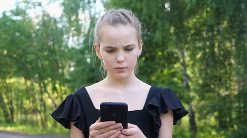 Teen Using a Phone in Nature Setting