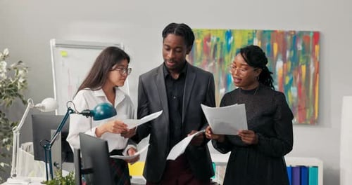 Cheerful Team Celebrates Success in Modern Office