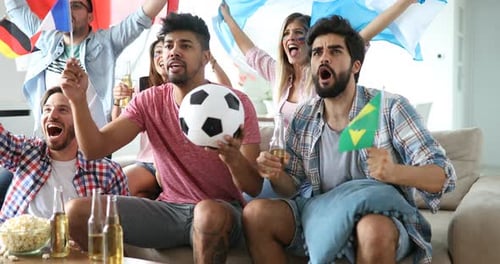Friends Cheering Watching Soccer Game on Television